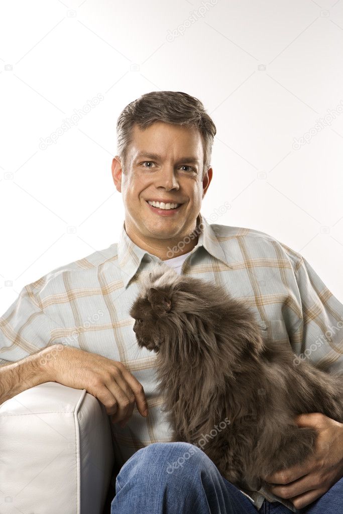 Caucasian man holding Persian cat.