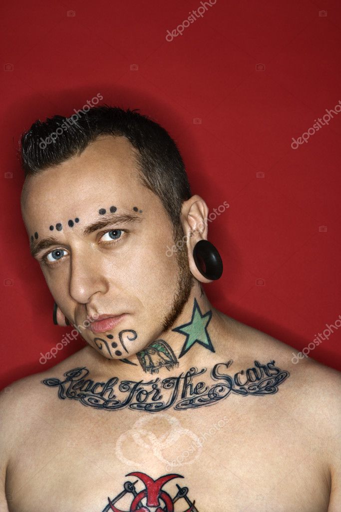 Man with tattoos and piercings. Stock Photo by ©iofoto 9434236