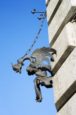 Gargoyle chained to wall. clipart