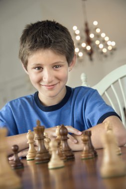 Boy playing chess. clipart