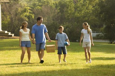 Family walking in park. clipart