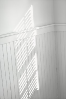 Sun through window blinds on wall. clipart