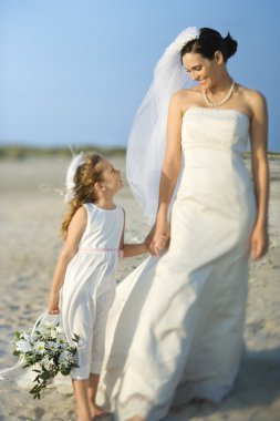 Bride and Flower Girl on Beach clipart