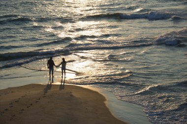 Aerial of couple on beach. clipart