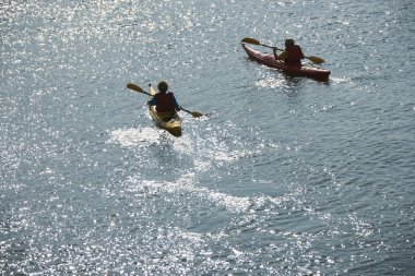 Boys in kayaks. clipart