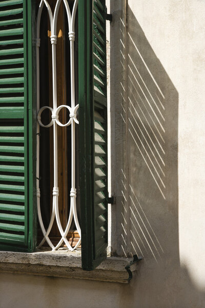 Close-up of window with shutters in Venice, Italy.