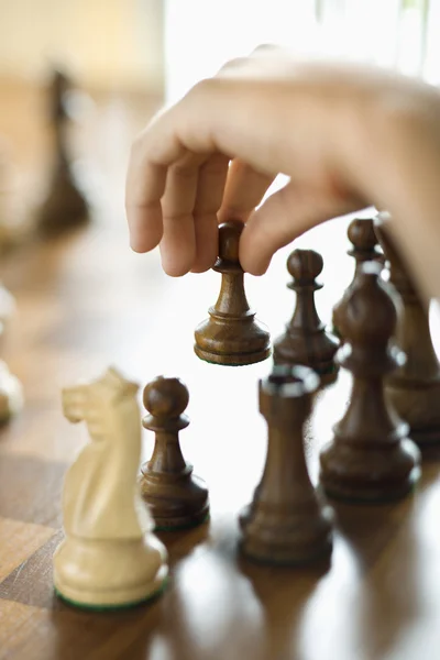Hand moving chess piece. — Stock Photo, Image