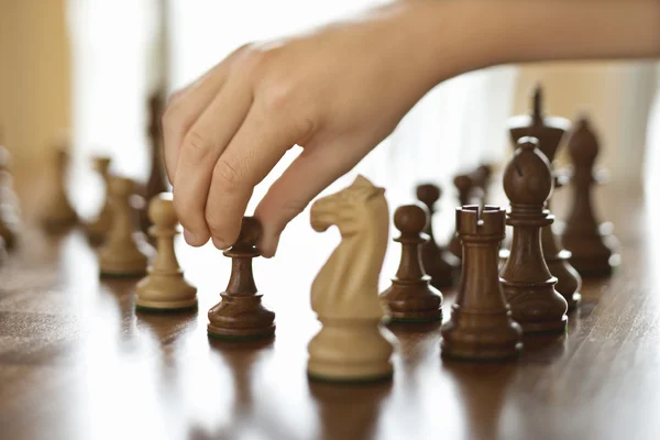 Hand moving chess piece. — Stock Photo, Image