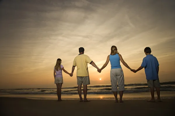 Family holding hands on beach — Stock Photo, Image