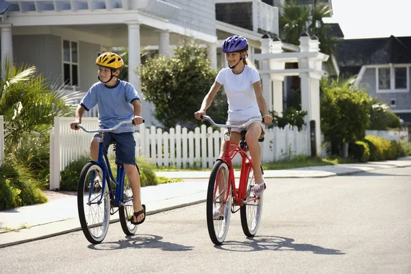 Niño y niña montando bicicletas — Foto de Stock