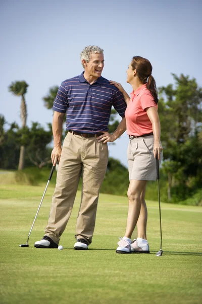 Пара розмовляє на полі для гольфу — стокове фото