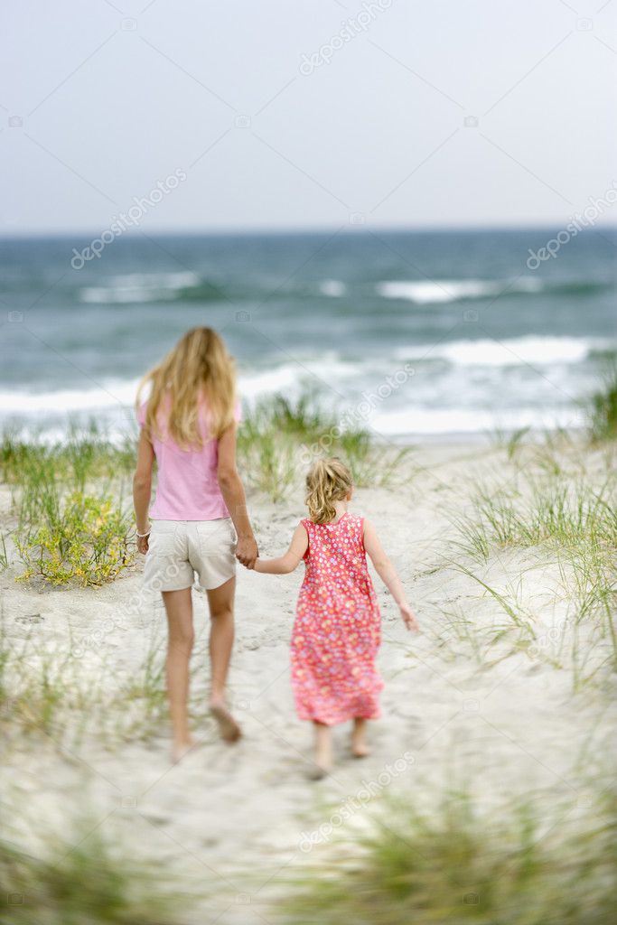 Sisters walking on beach.