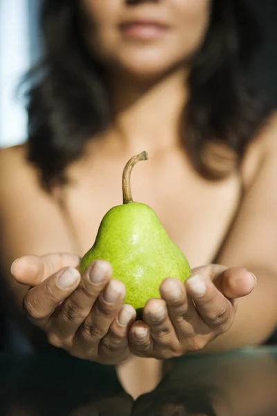 Vrouw bedrijf pear. — Stockfoto