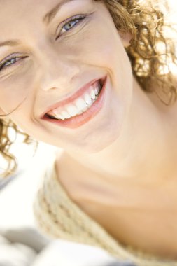 Close-up of woman's smiling face. clipart