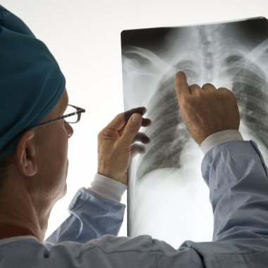 Physician reading xray. clipart