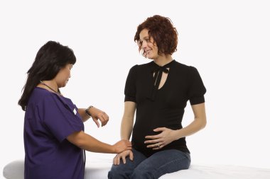 Pregnant woman and nurse. clipart