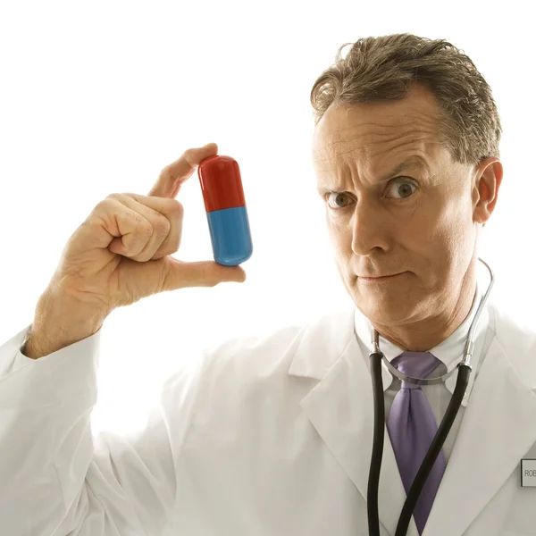 Doctor holding medicine. — Stock Photo, Image
