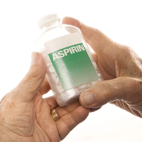 Mãos segurando garrafa de aspirina . — Fotografia de Stock