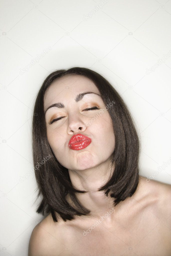 Woman puckering lips.