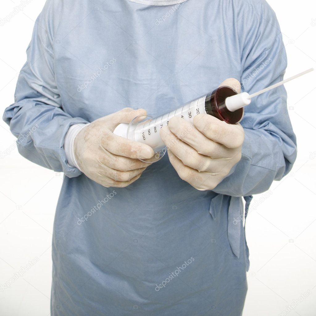 Surgeon holding giant needle.