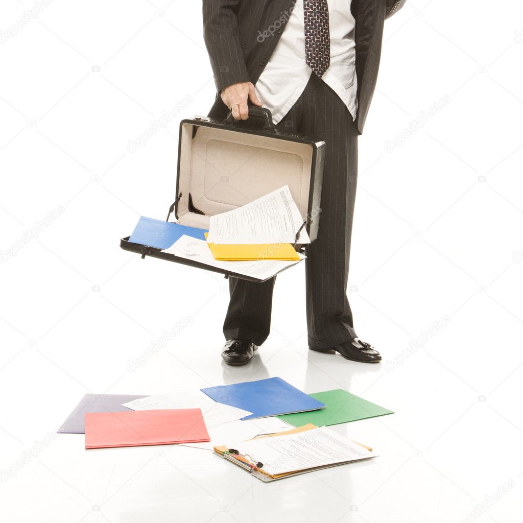 Businessman losing papers.