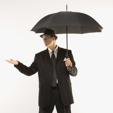 Businessman testing weather. clipart