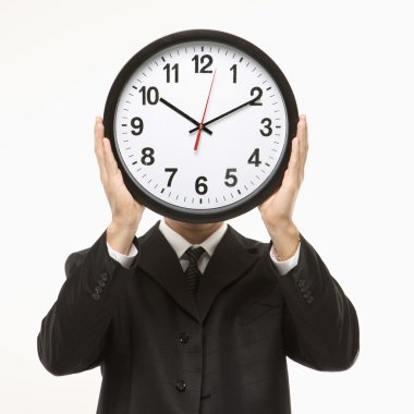 Clock in front of face. clipart