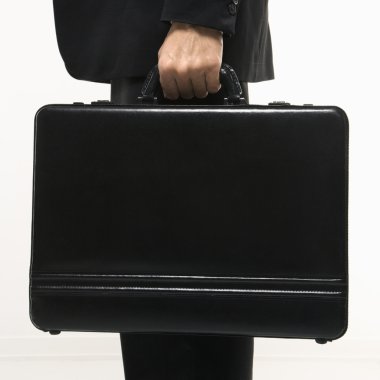 Businessman holding briefcase. clipart