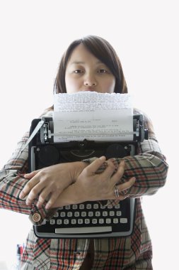 Woman holding typewriter. clipart