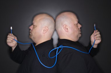 Twin men holding cable. clipart