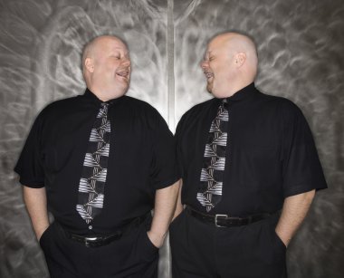 Twin bald men laughing. clipart