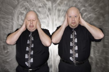 Twin men covering ears. clipart