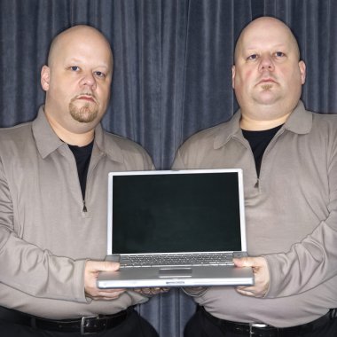 Twins with laptop. clipart