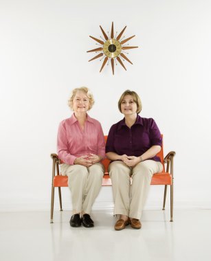 kadın gülümseyerek oturan.