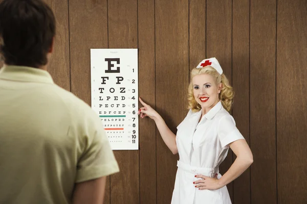 Nurse and eye chart. — Stock Photo, Image