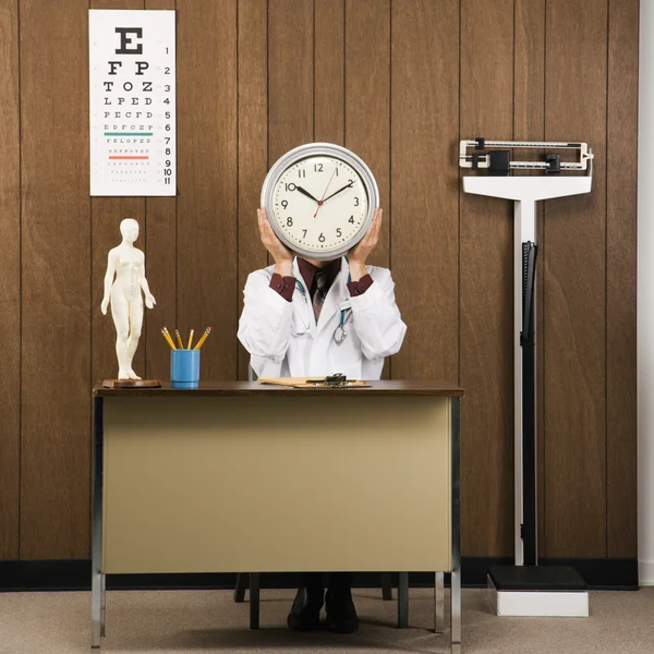 Doctor holding clock. — Stock Photo, Image