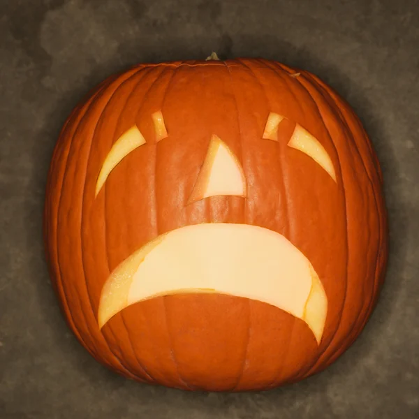 Sad carved pumpkin. — Stock Photo, Image