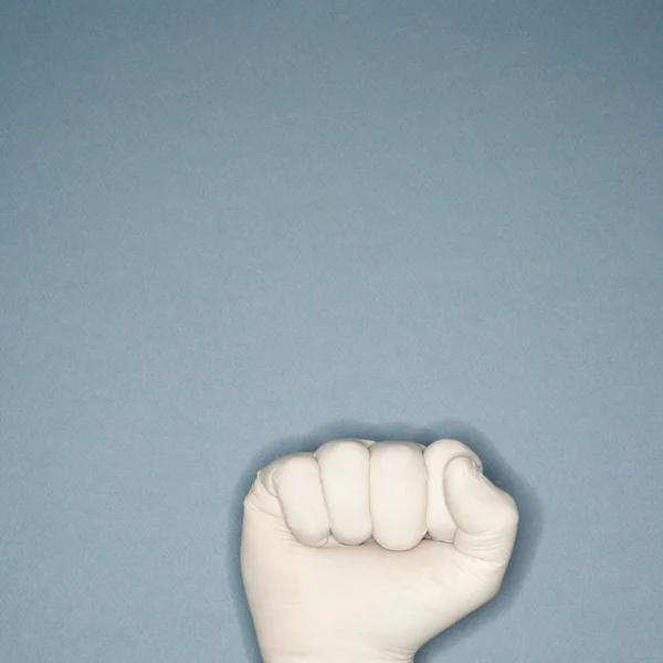 Fist wearing rubber glove. — Stock Photo, Image