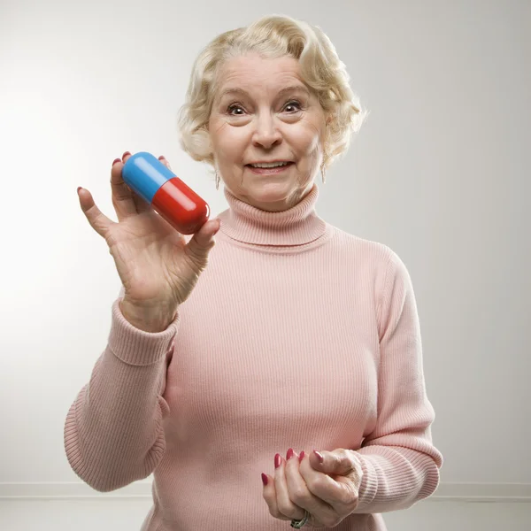 Woman holding pill. — Stock Photo, Image