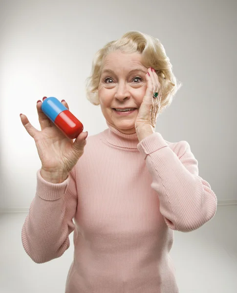 Woman holding pill. — Stock Photo, Image