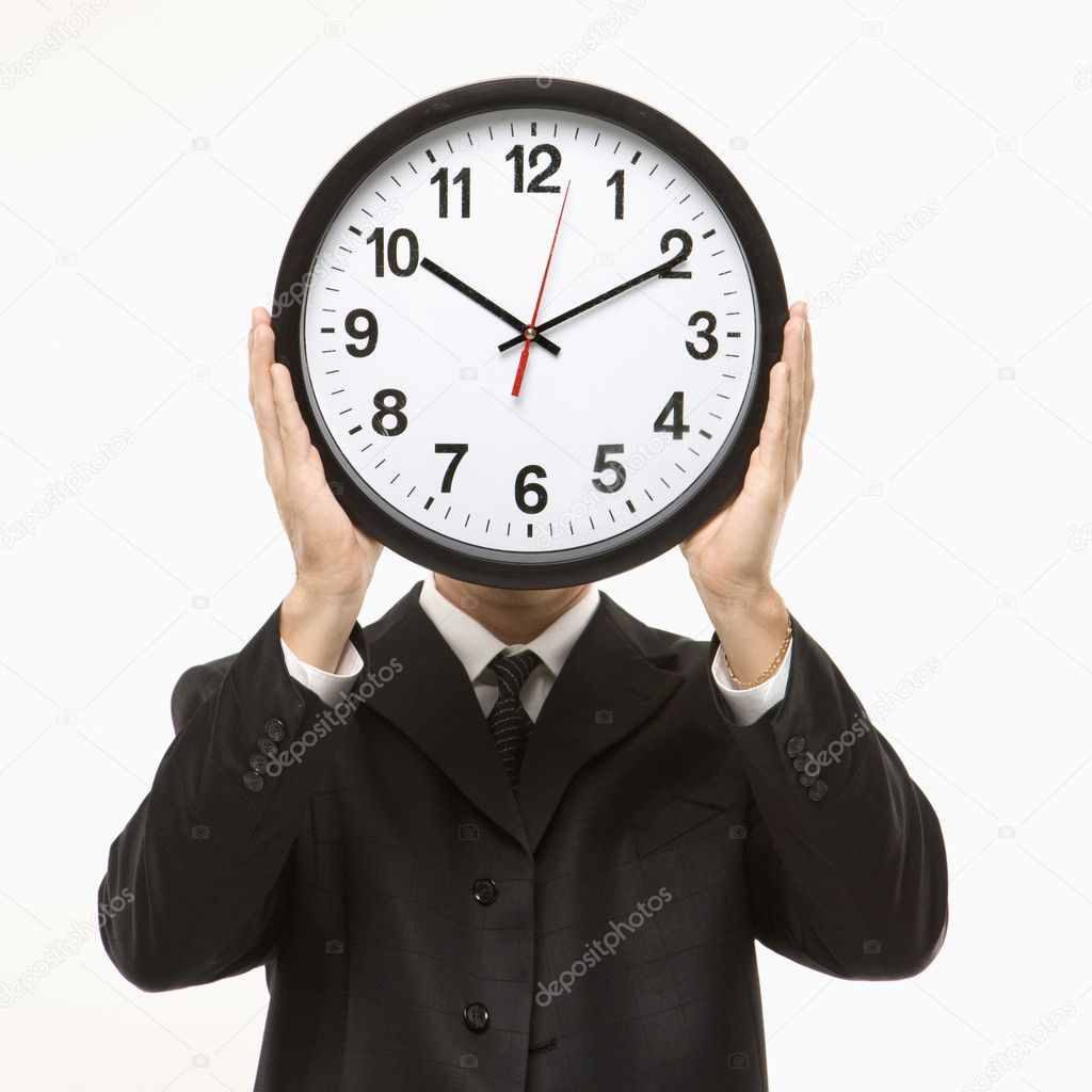 Clock in front of face.