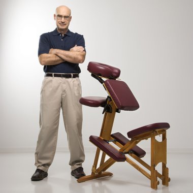 Massage therapist and chair. clipart