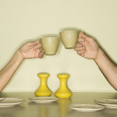 Hands toasting cups. clipart