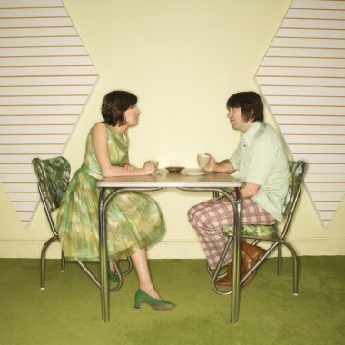 Couple sitting at table. clipart