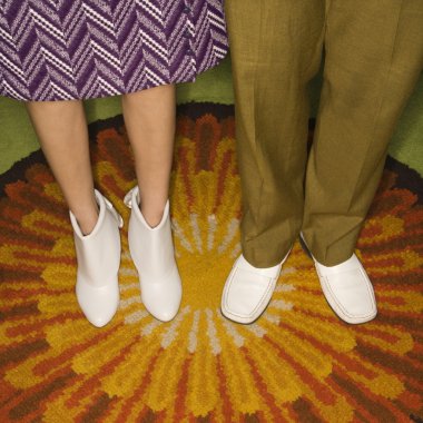 Couple's legs standing. clipart