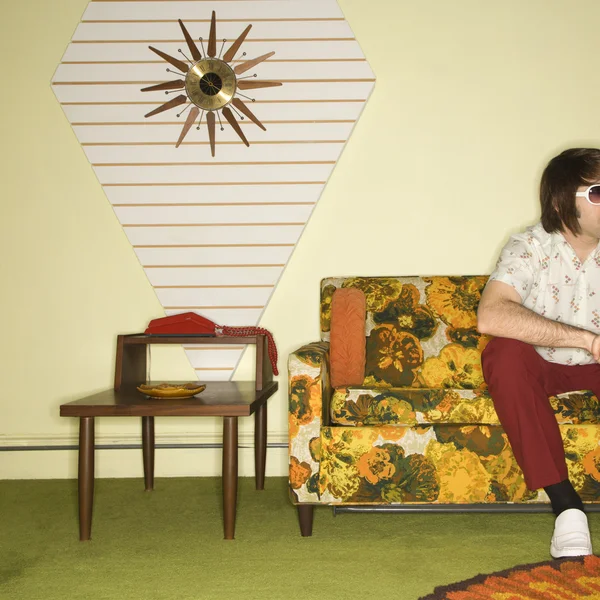 Man sitting on sofa. — Stock Photo, Image