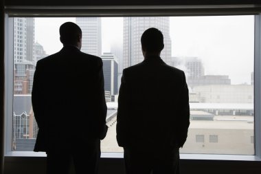 Businesspeople Looking Out of a Window clipart