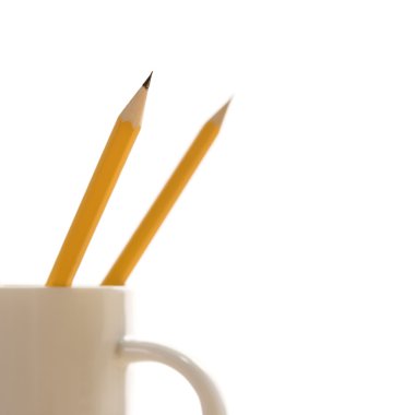 Pencils in coffee cup. clipart