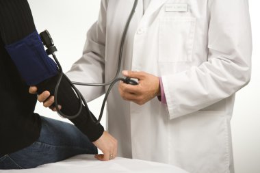 Doctor testing blood pressure. clipart