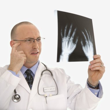 Doctor looking at xrays. clipart